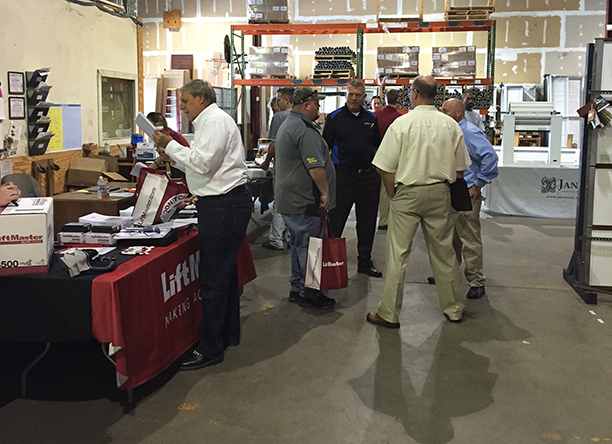 A group of Open House attendees socialize with each other and learn more about products stocked by the Door Center.