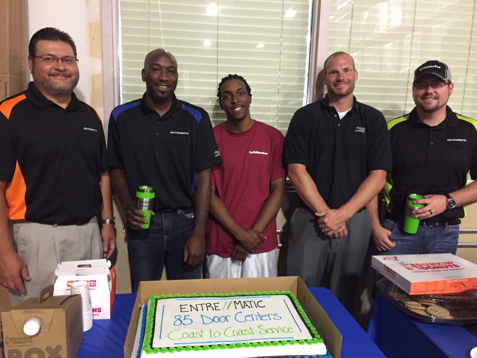 Kansas City Team Members pose with their Open House cake. Pictured from Left to Right: John Henderson, District Service Manager; Shannon Brown, General Manager; Dewan White, Warehouse; Drew Reno, Sales Manager; Luke Whittemore, Service Manager.