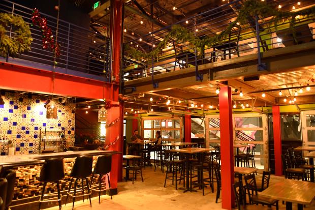 Stanley Marketplace interior with exposed beams and glass garage doors