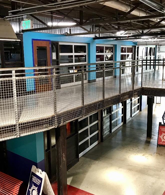 Adaptive reuse commercial interior with open walkways and glass doors