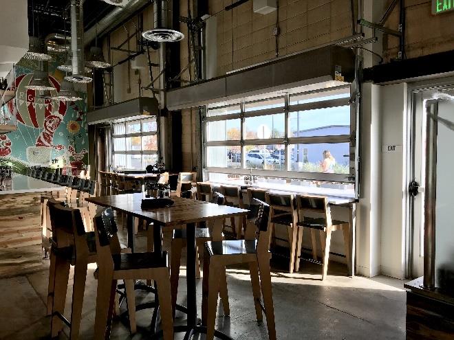 Restaurant space with full-view glass doors allowing natural light
