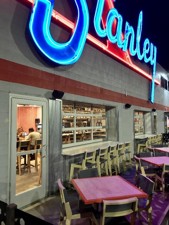 Commercial storefront with open glass doors at night in mixed-use development