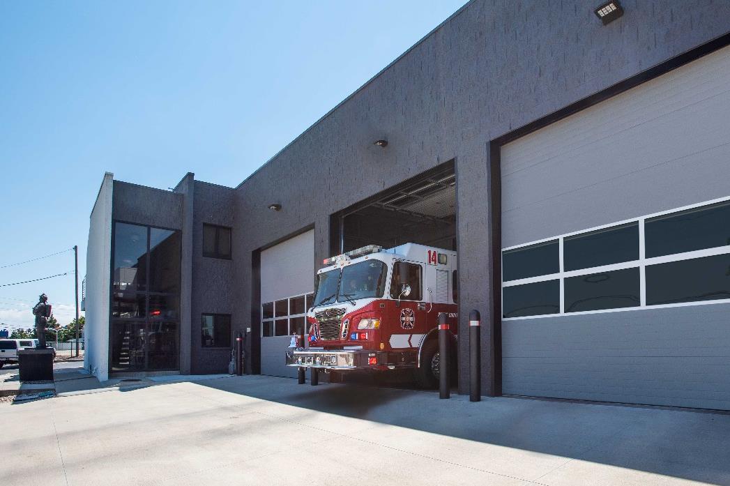 Fire station exterior with fire truck and insulated sectional garage doors