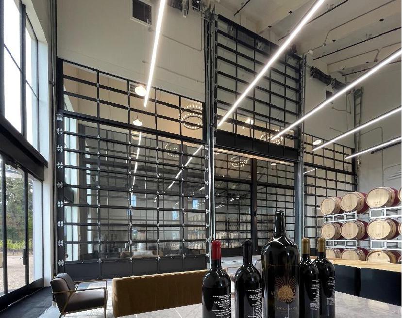 Winery barrel hall with full-view glass sectional doors