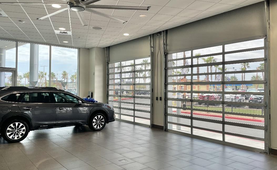 Subaru showroom interior with glass sectional doors and vehicle on display