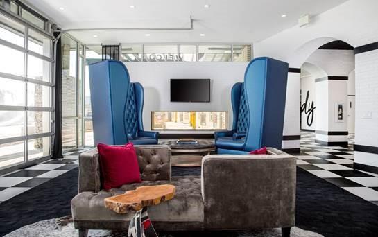 Luxury apartment lounge with modern seating and full-view glass doors