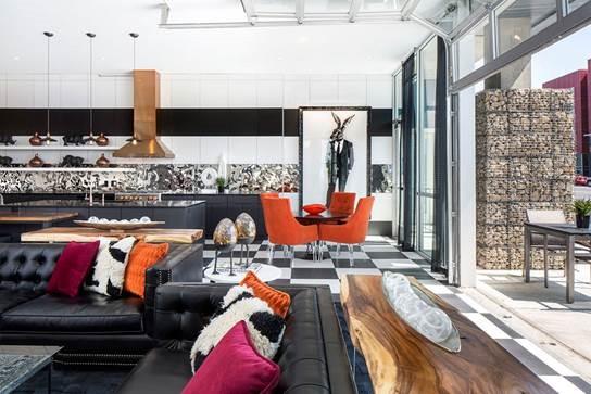 Apartment lounge with glass doors opening to outdoor seating area