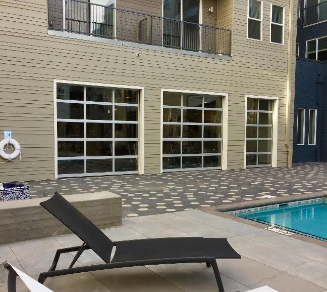 Apartment building exterior with pool deck and full-view doors