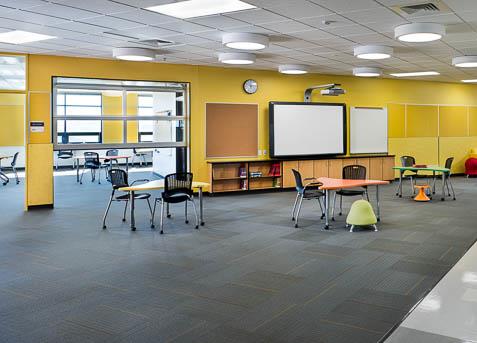 Classroom with movable furniture and glass doors for shared learning space