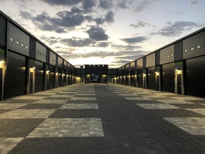 Drive-through garage condo layout with multiple steel sectional doors