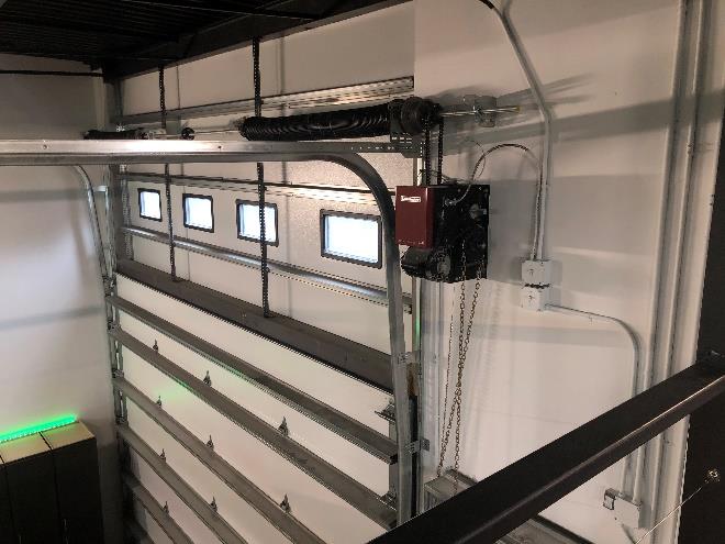 Heavy-duty garage door hardware and high-lift track inside storage unit