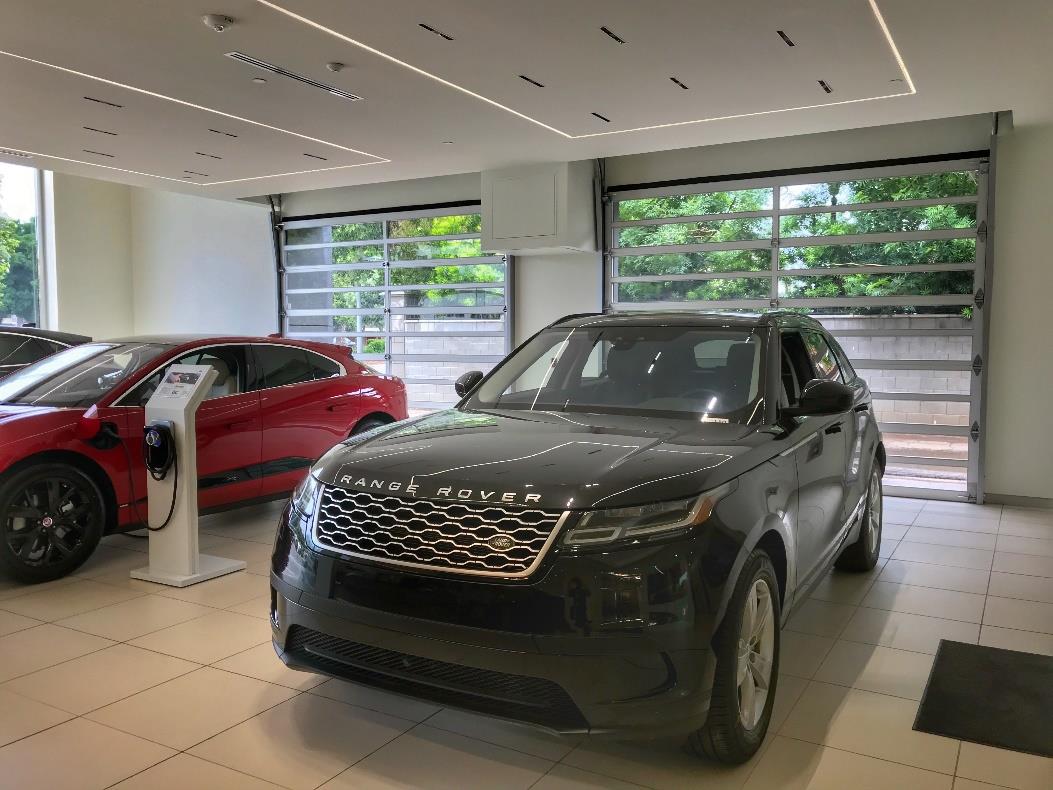 Haron Motor Sales dealership interior with modern glass garage doors
