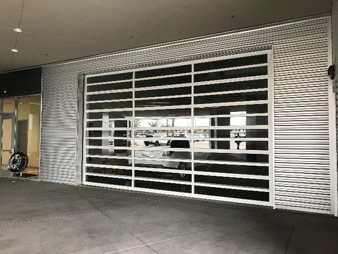 Service bay with aluminum glass sectional door and horizontal mullions