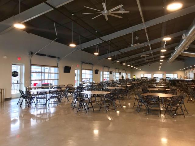 Restaurant interior at ISM Raceway with open layout and large glass doors