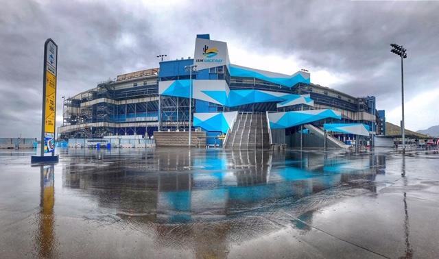 Modern stadium hospitality building with glass doors and outdoor access