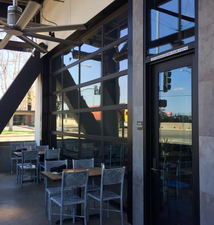 Brewpub patio with glass garage doors opening to outdoor dining area