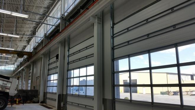 Industrial service facility interior with multiple overhead doors and natural light