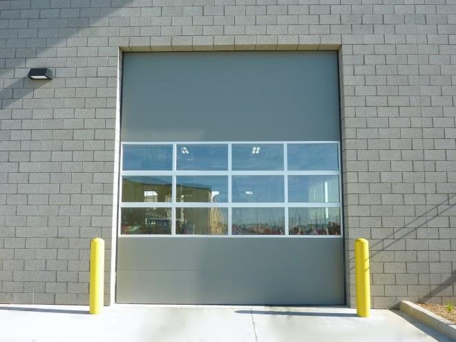 Hybrid sectional door with insulated steel panels and glass window sections
