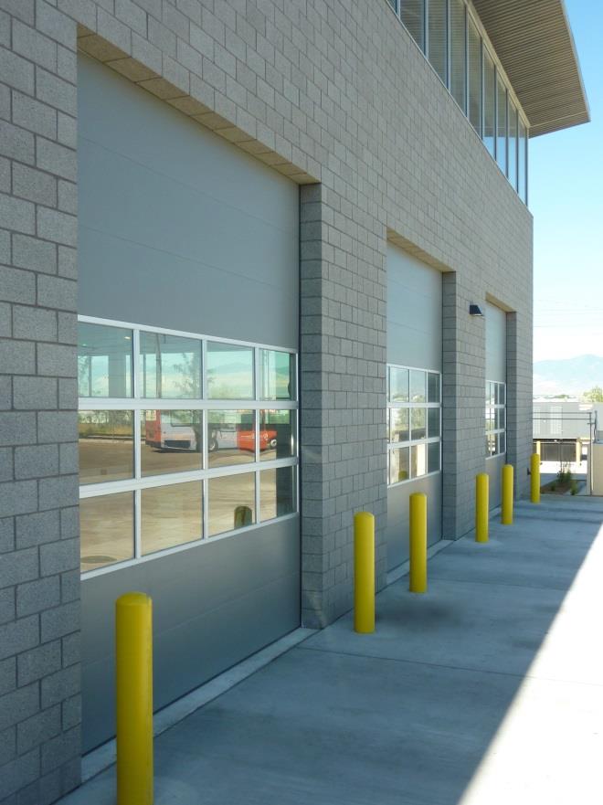 Row of service bay doors with glass sections at fleet maintenance facility