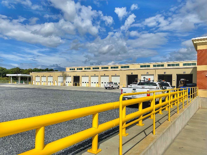 Industrial facility exterior walkway with safety railings and building facade