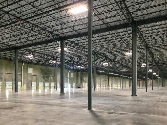 Empty warehouse interior showing structural columns and open floor space
