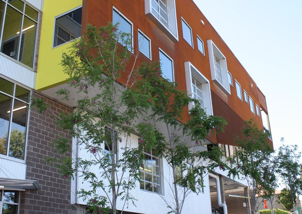 Modern multi-tenant office building with colorful facade and glass sectional doors