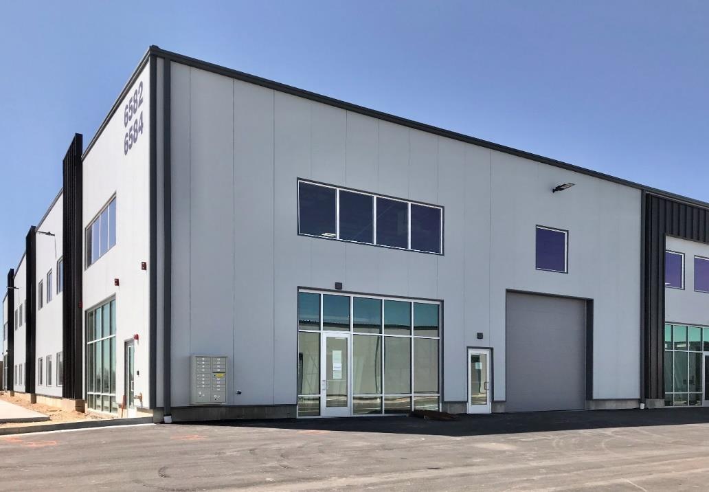 Industrial warehouse exterior with large garage doors and modern facade
