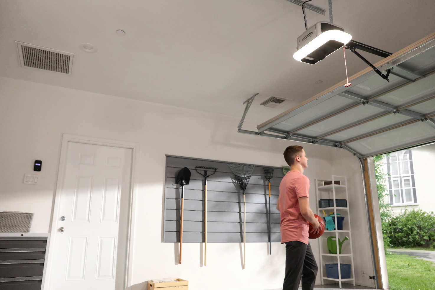 Brightly lit, organized garage interior  LED lighting from opener illuminating full space